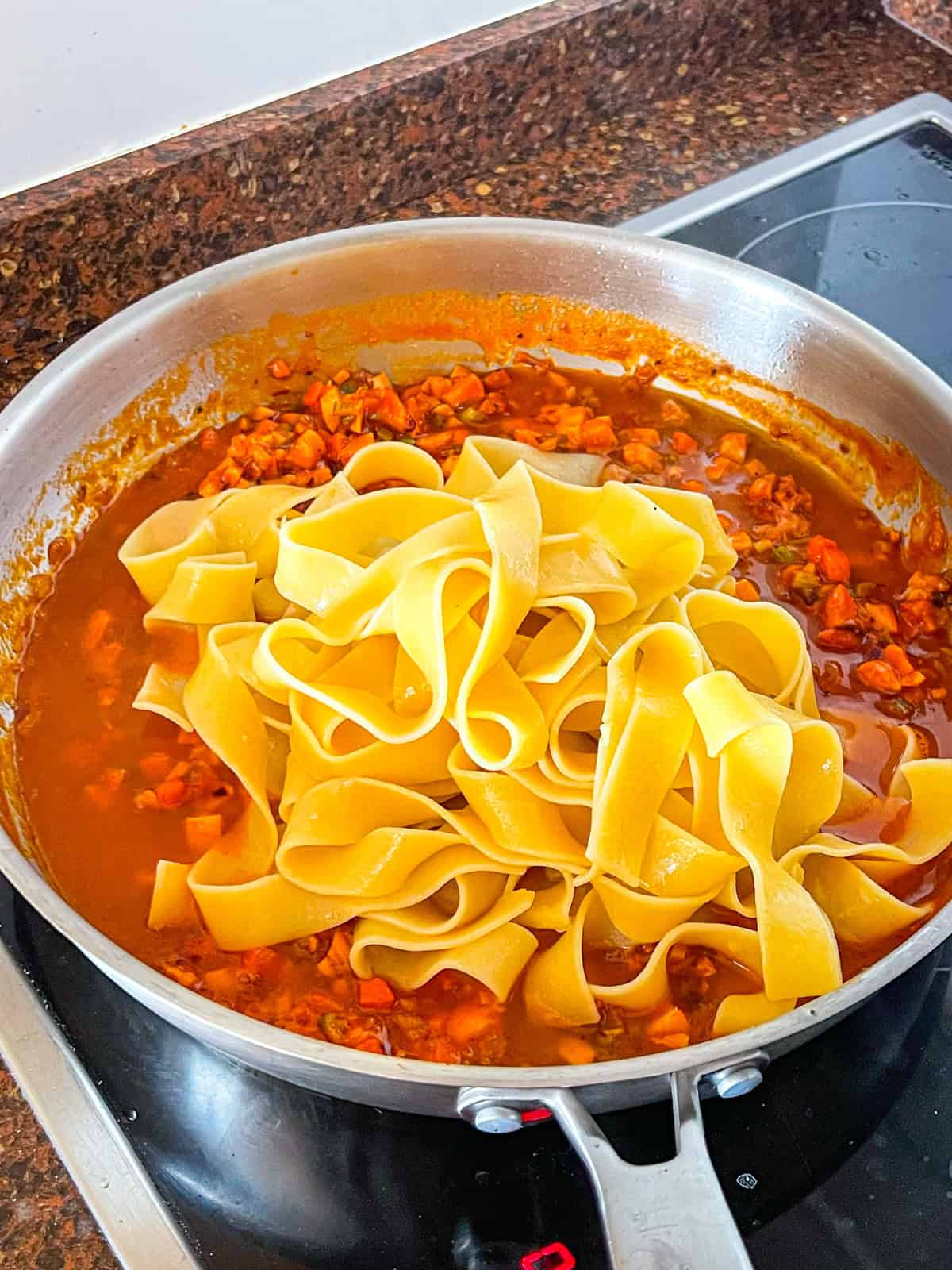 pappardelle tossed with ragu and pasta water.
