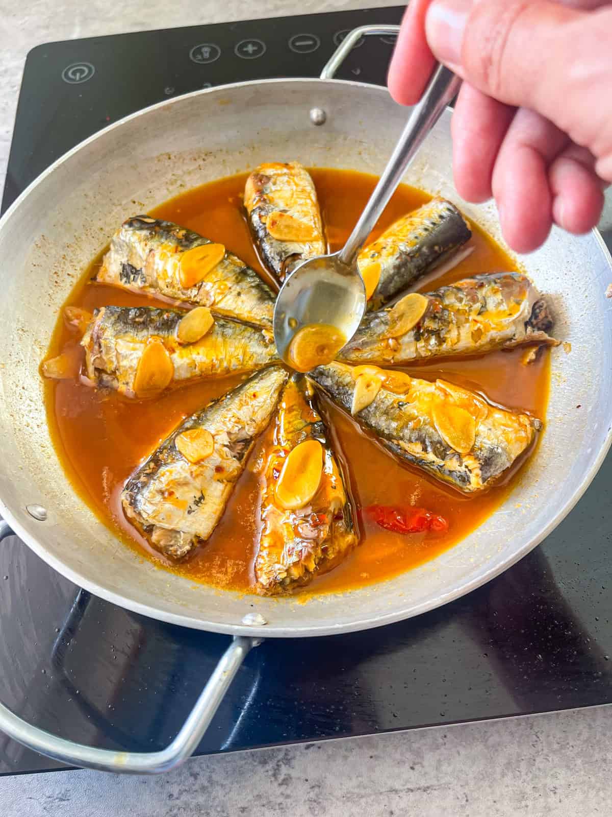 Portuguese garlic sardines in a sauce with garlic.