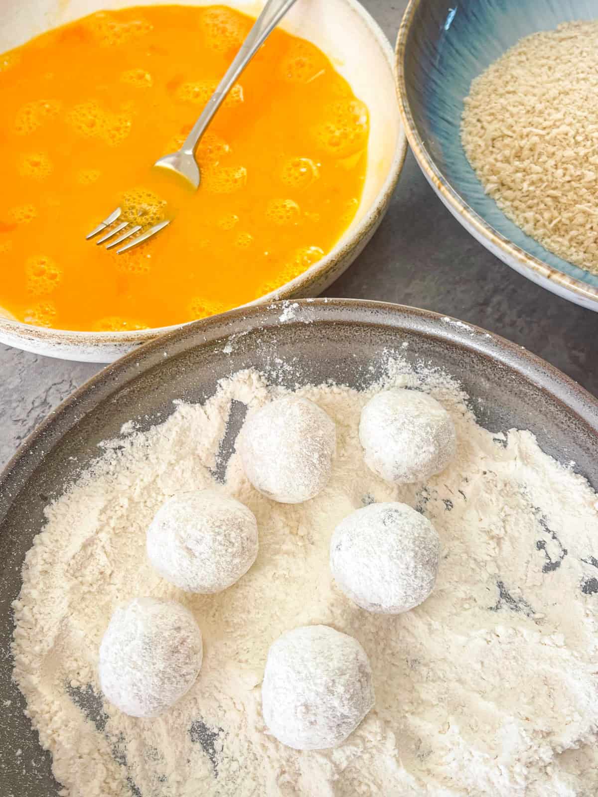 croquetas breaded in flour before going into egg and panko.